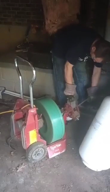 Our technician operating professional drain cleaning equipment on a job in Jefferson City, MO